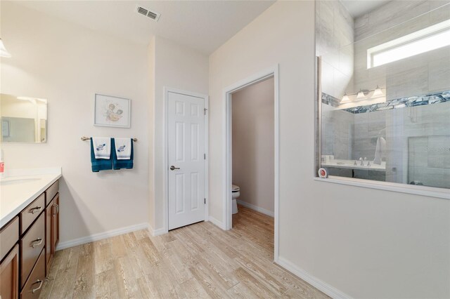 6868 SW 95th Cir, Ocala, FL 34481 - full bath with walk in shower, toilet, wood finished floors, vanity, and baseboards