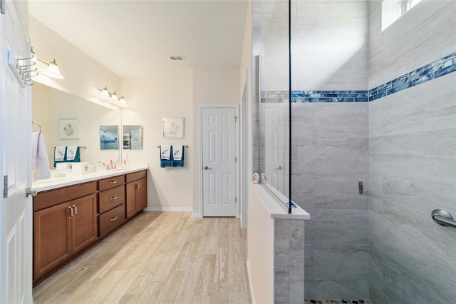 6868 SW 95th Cir, Ocala, FL 34481 - full bathroom featuring wood finished floors, a walk in shower, double vanity, and baseboards