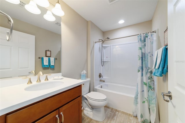 6868 SW 95th Cir, Ocala, FL 34481 - bathroom featuring wood finished floors, vanity, shower / bath combo, and toilet