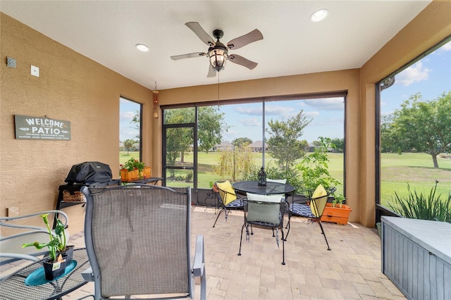6868 SW 95th Cir, Ocala, FL 34481 - sunroom / solarium with outdoor dining area, a ceiling fan, and view of golf course