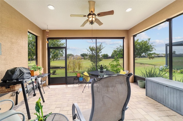 6868 SW 95th Cir, Ocala, FL 34481 - sunroom with golf course view, ceiling fan, exterior kitchen, and outdoor dining space