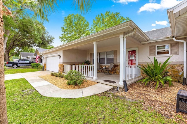 8874 SW 95th St Unit E, Ocala, FL 34481 - view of front of house with a porch, stone siding, an attached garage, and concrete driveway