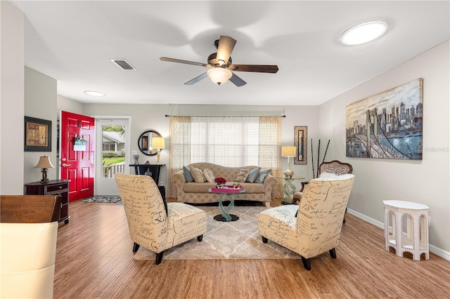 8874 SW 95th St Unit E, Ocala, FL 34481 - living area featuring wood finished floors, ceiling fan, and baseboards