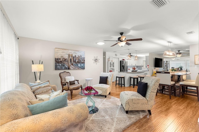 8874 SW 95th St Unit E, Ocala, FL 34481 - living room featuring a ceiling fan and light wood-style floors