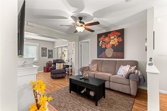 8874 SW 95th St Unit E, Ocala, FL 34481 - living area featuring wood finished floors, a ceiling fan, and baseboards