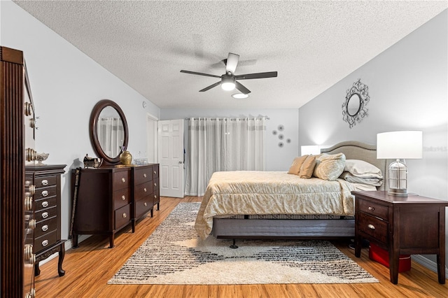 8874 SW 95th St Unit E, Ocala, FL 34481 - bedroom with wood finished floors, a textured ceiling, and ceiling fan