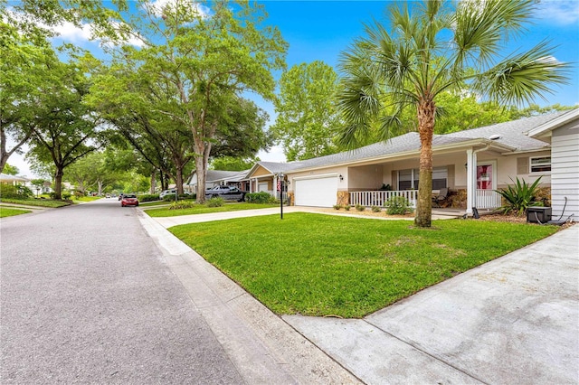 8874 SW 95th St Unit E, Ocala, FL 34481 - ranch-style house featuring a garage, a porch, driveway, a front lawn, and stucco siding