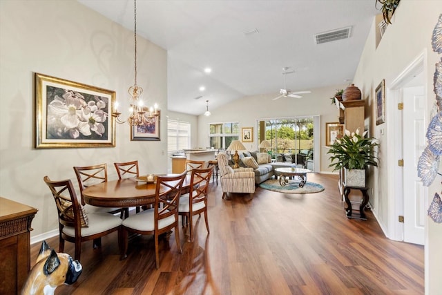 dining room featuring wood finished floors, a ceiling fan, lofted ceiling, a chandelier, and baseboards