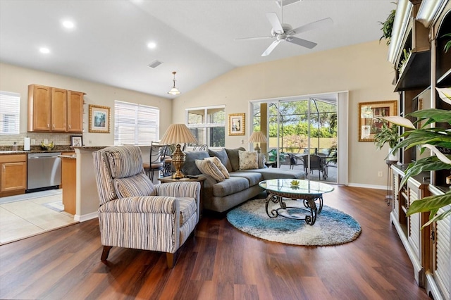 living area featuring light wood-type flooring, vaulted ceiling, ceiling fan, baseboards, and recessed lighting