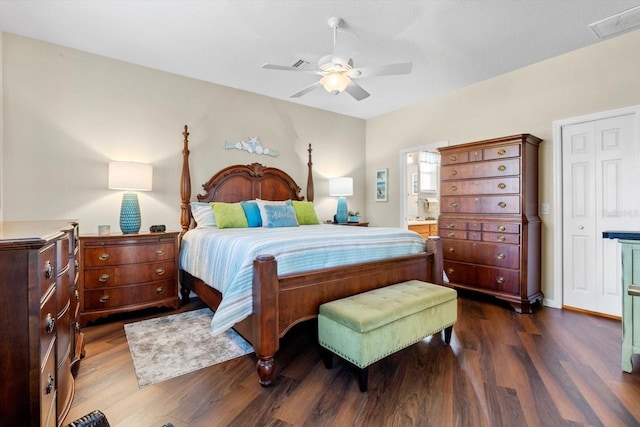 bedroom featuring wood finished floors, ensuite bathroom, and ceiling fan