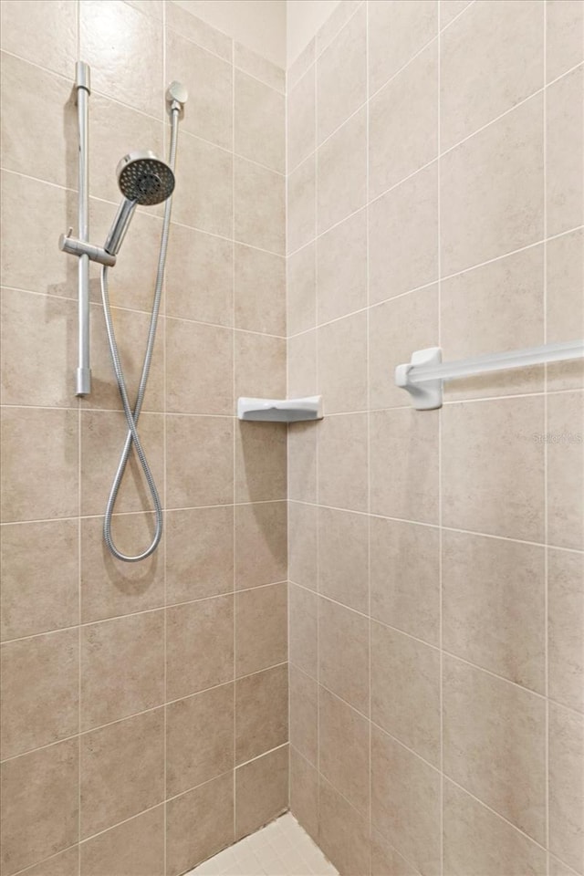 full bath featuring tiled shower