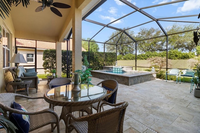 view of patio / terrace with an outdoor hot tub, glass enclosure, a ceiling fan, and outdoor dining space