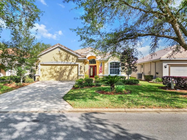 ranch-style home with central air condition unit, a garage, stucco siding, and concrete driveway