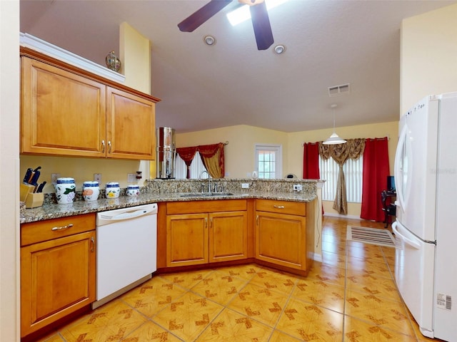 9325 SW 125th Court Rd, Dunnellon, FL 34432 - kitchen featuring white appliances, a sink, a peninsula, brown cabinets, and a ceiling fan
