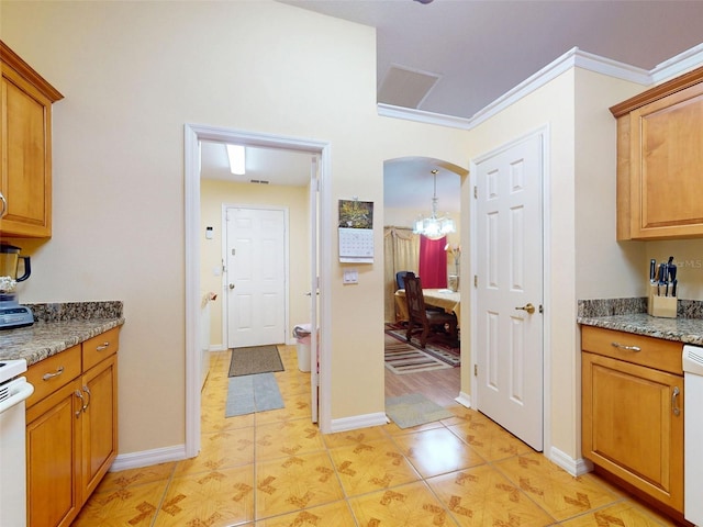9325 SW 125th Court Rd, Dunnellon, FL 34432 - kitchen with brown cabinets, arched walkways, light tile patterned floors, and light stone counters