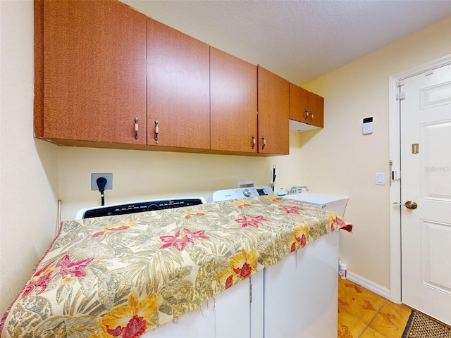 9325 SW 125th Court Rd, Dunnellon, FL 34432 - laundry room featuring cabinet space, baseboards, washer / clothes dryer, and light wood-type flooring