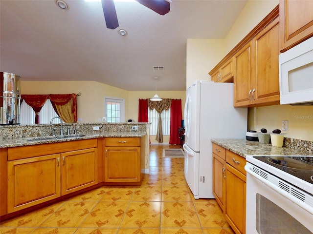 9325 SW 125th Court Rd, Dunnellon, FL 34432 - kitchen with a sink, white appliances, brown cabinetry, ceiling fan, and light stone countertops