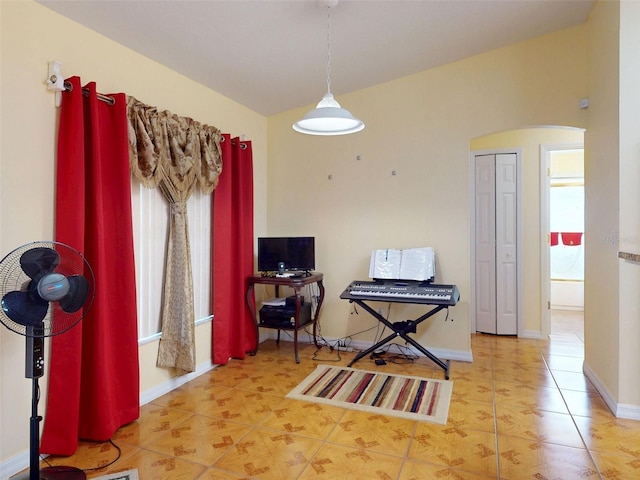 9325 SW 125th Court Rd, Dunnellon, FL 34432 - tiled dining area with arched walkways, baseboards, and vaulted ceiling