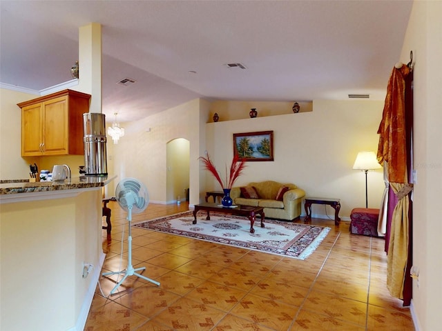 9325 SW 125th Court Rd, Dunnellon, FL 34432 - living room featuring arched walkways, vaulted ceiling, light tile patterned floors, and baseboards