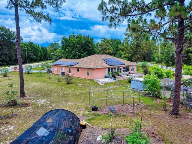 9325 SW 125th Court Rd, Dunnellon, FL 34432 - rear view of property with a patio, solar panels, stucco siding, and central air condition unit