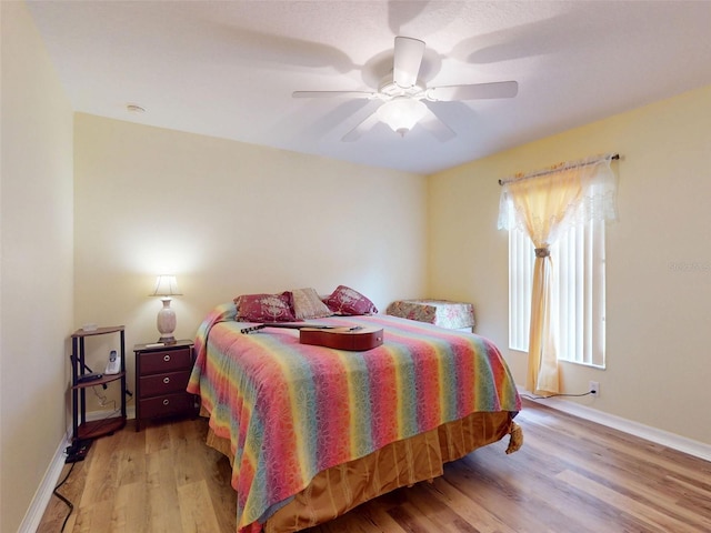 9325 SW 125th Court Rd, Dunnellon, FL 34432 - bedroom featuring wood finished floors, baseboards, and ceiling fan