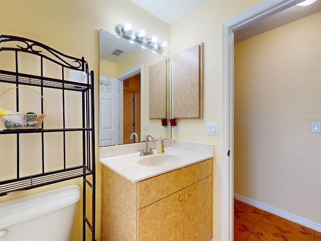 9325 SW 125th Court Rd, Dunnellon, FL 34432 - bathroom with toilet, vanity, and baseboards