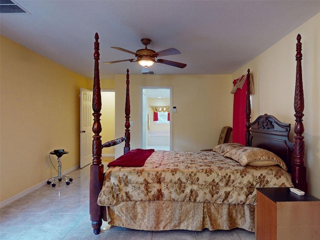 9325 SW 125th Court Rd, Dunnellon, FL 34432 - tiled bedroom with baseboards, ensuite bath, and a ceiling fan
