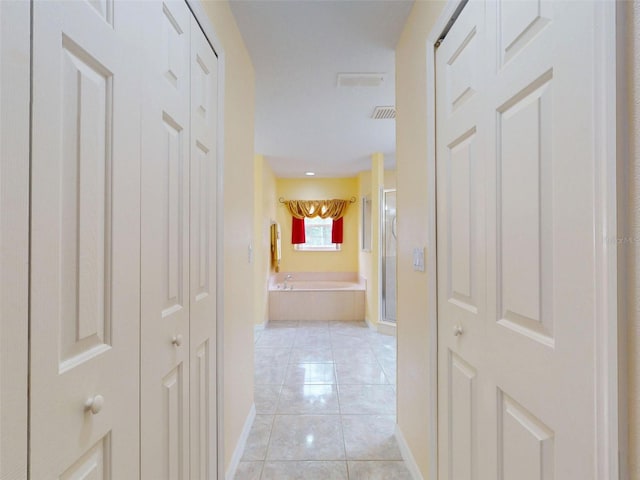 9325 SW 125th Court Rd, Dunnellon, FL 34432 - corridor featuring baseboards and light tile patterned floors