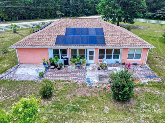9325 SW 125th Court Rd, Dunnellon, FL 34432 - rear view of property with a patio area, roof mounted solar panels, and stucco siding