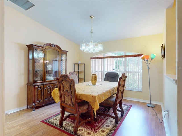 9325 SW 125th Court Rd, Dunnellon, FL 34432 - dining room featuring light wood-style floors, a chandelier, and vaulted ceiling