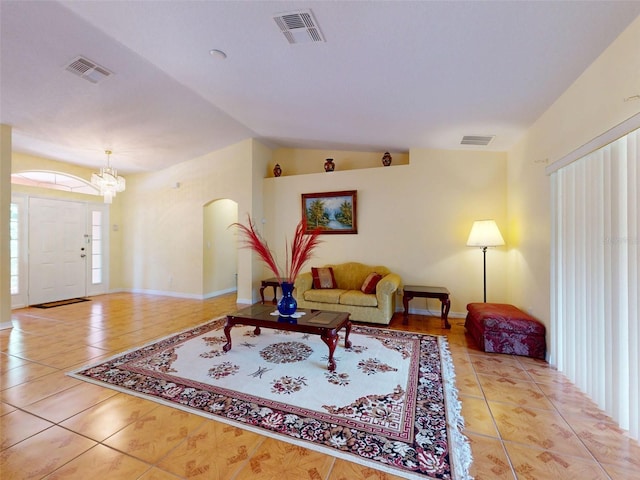 9325 SW 125th Court Rd, Dunnellon, FL 34432 - living area with tile patterned flooring, lofted ceiling, a chandelier, and arched walkways