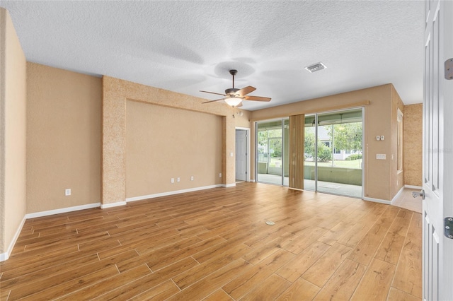 6651 SW 93rd Ct, Ocala, FL 34481 - spare room featuring ceiling fan, light wood-style flooring, baseboards, and a textured ceiling