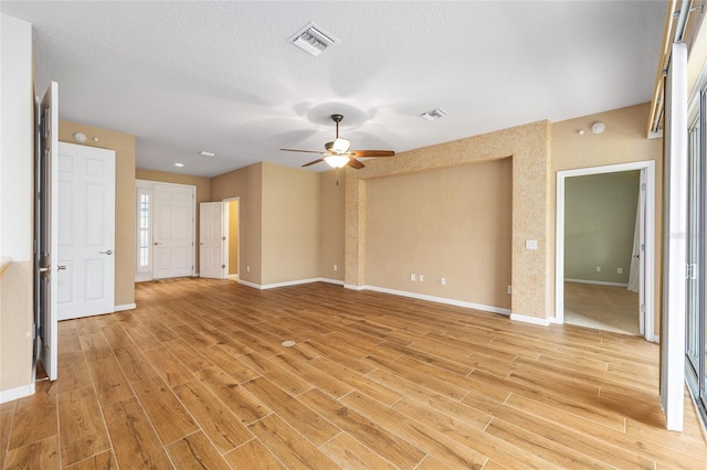 6651 SW 93rd Ct, Ocala, FL 34481 - unfurnished room with light wood-type flooring, a ceiling fan, baseboards, and a textured ceiling