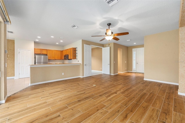 6651 SW 93rd Ct, Ocala, FL 34481 - unfurnished living room featuring light wood-type flooring, baseboards, ceiling fan, and recessed lighting