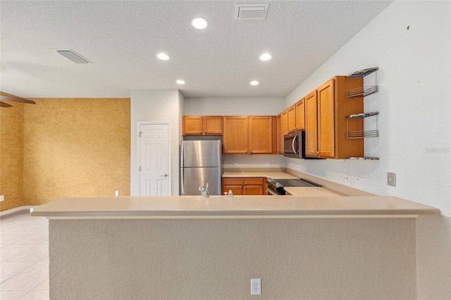 6651 SW 93rd Ct, Ocala, FL 34481 - kitchen with appliances with stainless steel finishes, light countertops, recessed lighting, a peninsula, and brown cabinetry