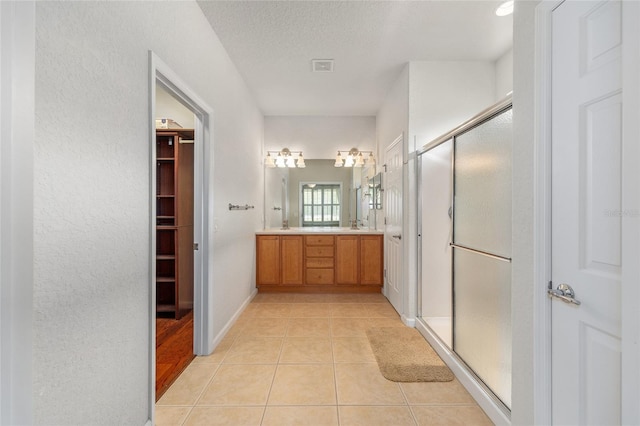 6651 SW 93rd Ct, Ocala, FL 34481 - full bath featuring a shower stall, tile patterned flooring, double vanity, and a textured ceiling