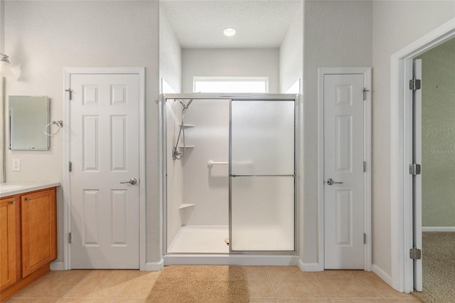 6651 SW 93rd Ct, Ocala, FL 34481 - bathroom featuring a shower stall, tile patterned floors, vanity, and baseboards