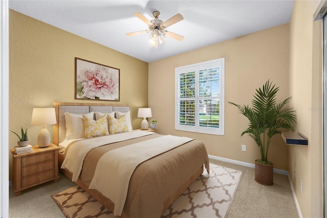 6651 SW 93rd Ct, Ocala, FL 34481 - bedroom with baseboards, light colored carpet, and a ceiling fan