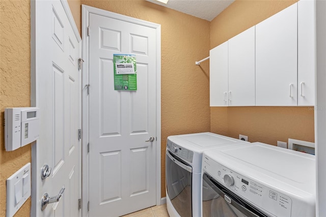6651 SW 93rd Ct, Ocala, FL 34481 - washroom featuring cabinet space, separate washer and dryer, a textured wall, and light tile patterned flooring