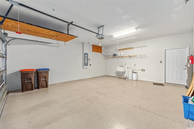 6651 SW 93rd Ct, Ocala, FL 34481 - garage with a garage door opener, electric panel, and a sink