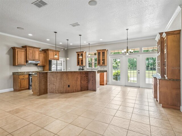 2540 NE 120th St, Anthony, FL 32617 - kitchen featuring appliances with stainless steel finishes, brown cabinetry, a center island, recessed lighting, and ornamental molding