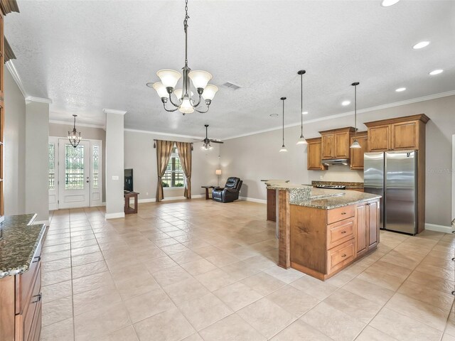 2540 NE 120th St, Anthony, FL 32617 - kitchen featuring freestanding refrigerator, a chandelier, recessed lighting, brown cabinetry, and open floor plan