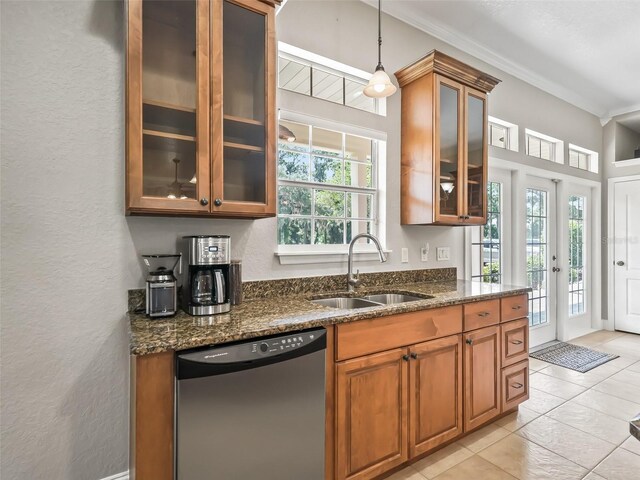 2540 NE 120th St, Anthony, FL 32617 - kitchen featuring dishwasher, a sink, plenty of natural light, brown cabinetry, and a textured wall