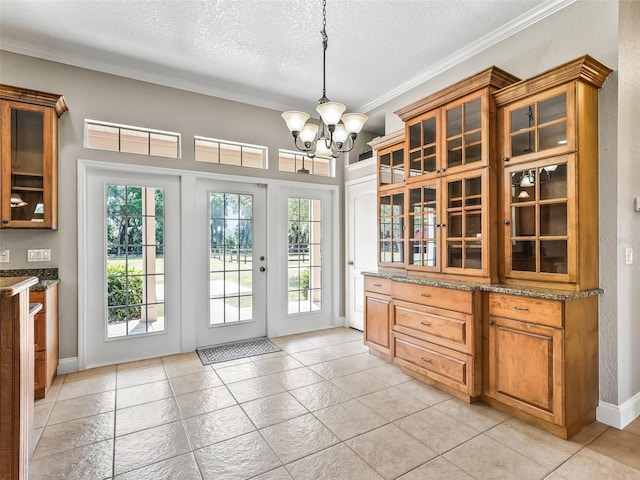 2540 NE 120th St, Anthony, FL 32617 - doorway featuring a chandelier, a textured ceiling, ornamental molding, baseboards, and light tile patterned floors
