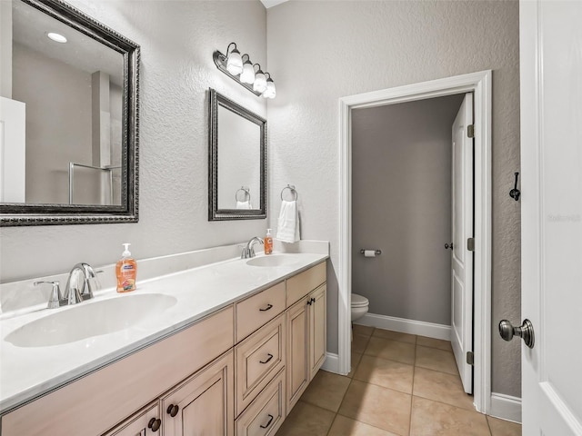 2540 NE 120th St, Anthony, FL 32617 - full bath featuring toilet, tile patterned floors, double vanity, and a textured wall