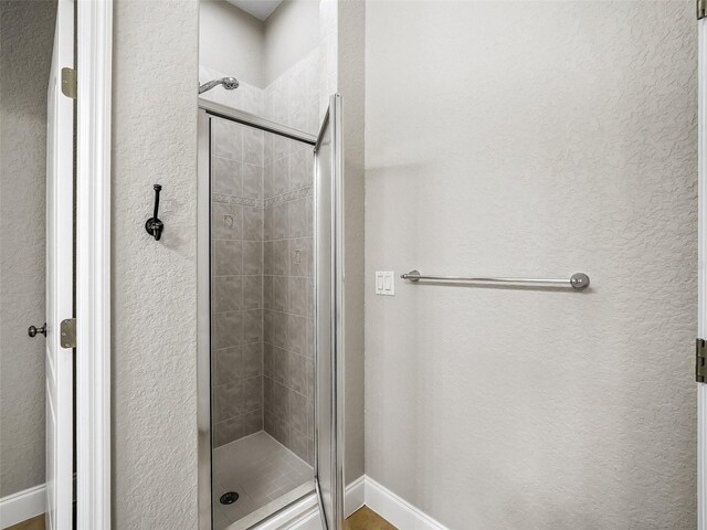 2540 NE 120th St, Anthony, FL 32617 - full bathroom with a stall shower, baseboards, and a textured wall