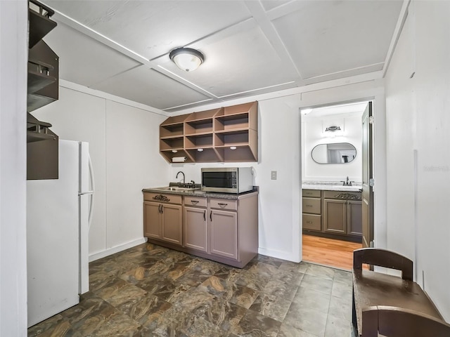 2540 NE 120th St, Anthony, FL 32617 - kitchen with stainless steel microwave, freestanding refrigerator, open shelves, and a sink