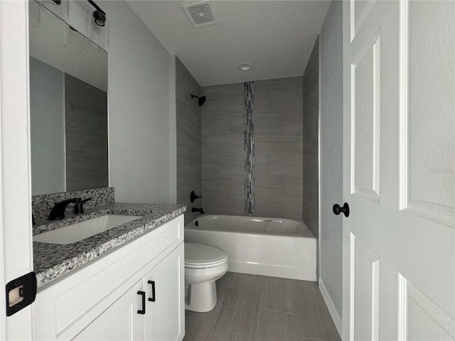 full bath with toilet, vanity, and tub / shower combination