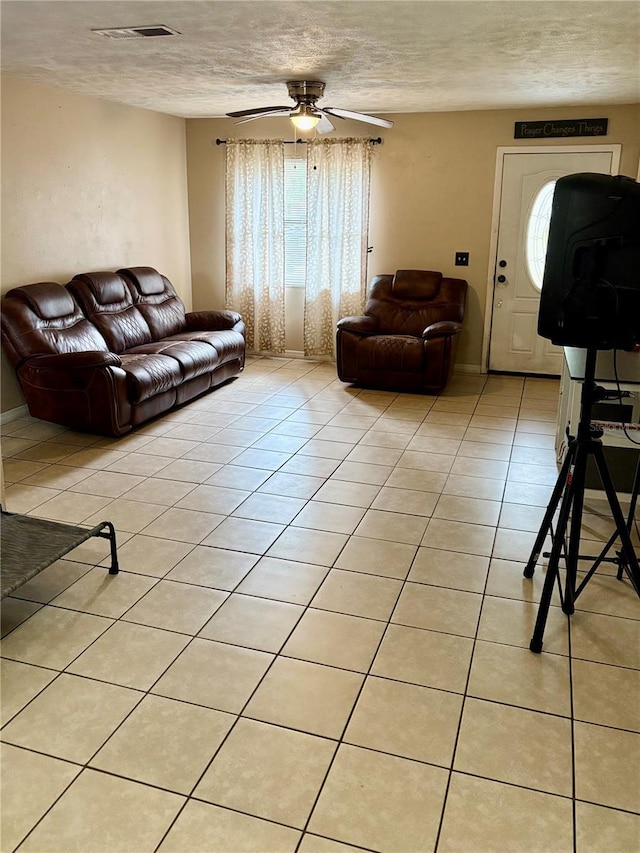 5549 NW 64th St, Ocala, FL 34482 - living area featuring a textured ceiling, light tile patterned floors, and ceiling fan