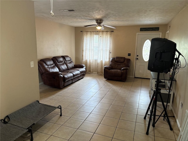 5549 NW 64th St, Ocala, FL 34482 - living area featuring light tile patterned floors, ceiling fan, and a textured ceiling